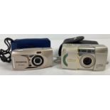 An Olympus I zoom 75 Multi AF camera with case together with a Nikon Lite Touch Zoom 140ED AF camera
