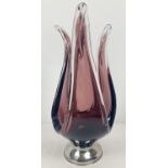 A large vintage aubergine glass dish raised on a stainless steel foot. Approx. 41cm tall.