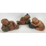 3 carved wooden figurines of Oriental sleeping children. With painted colour detail. Each approx.