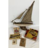 A small collection of assorted vintage toys to include and wooden pond yacht. Lot also includes: Cow