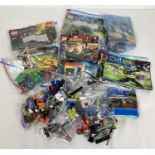 A collection of assorted Lego play pieces and instruction manuals. To include: Chima, Lord of the