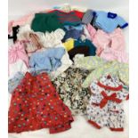 A collection of vintage medium and small dolls clothes to include dresses, blouses romper suits,