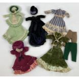 A collection of assorted vintage handmade dolls clothes suitable for 8" dolls. To include dresses