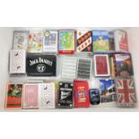 A collection of 32 sets of playing cards, some still sealed. To include Jack Daniels sealed pack