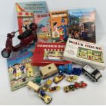 A box of assorted toys to include: teaching jig-saws, Barbie Vespa bike, vintage annuals and diecast