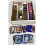 A box of assorted vintage and more modern baseball and basketball trading cards. To include Topps,