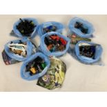 A collection of assorted Lego Bionicle play pieces and instructions.