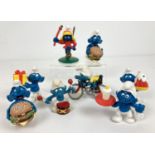 A collection of 8 Macdonald's and vintage Peyo Smurf figures. Comprising: 2 x burger, girl Smurf