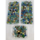 A collection of vintage glass marbles to include core swirl, banded swirls and opaque. In varying