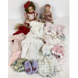 2 vintage jointed dolls together with a quantity of assorted dolls clothing. A hard plastic Pedigree