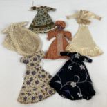 A collection of assorted vintage handmade dolls clothes suitable for 8" dolls. To included