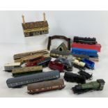 A tub of assorted vintage accessories, wagons and locomotives in varying sizes and conditions. To