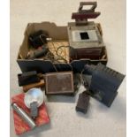 A box of early camera and film equipment. To include an early magic lantern/projector, red