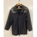 A vintage dark blue wool Donkey Jacket with vinyl shoulder panel by Dudes. Button fastening with two