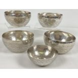5 vintage Anglo-Indian white metal bowls with hammered designs to outer bowl. A set of 4 matching