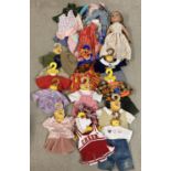 An Our Generation style vinyl doll with a collection of assorted handmade dolls clothes. Together