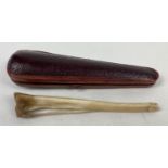 A vintage cheroot holder made from a animal fibula leg bone. Complete with period leather velvet