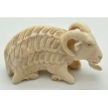 An Antique carved ivory figure of a long haired ram. Approx. 3.5 x 6cm.