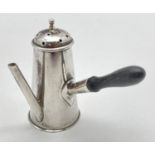 An antique silver novelty pepperette modelled as a wooden handled chocolate pot. Hallmarked