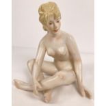 An Austrian Wien porcelain nude figurine of cross legged lady in an Art Deco style. With hand
