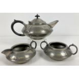 An antique Arts and Crafts pewter tea set by Civic, No. 3476. With hammered detail and trefoil style