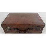 A vintage leather small suitcase/briefcase with leather carry handle and interior documents