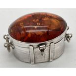 A 925 silver trinket pot set with large amber cabochon to lid. Silver hinge lidded pot in the form