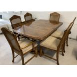 A vintage solid wood dining room table with 4 matching dining chairs and 2 carvers. Table has