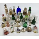 A collection of vintage glass perfume bottles in varying sizes and designs. Some with contents. To