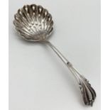 A Robert Pringle Edwardian silver sugar sifting spoon with decorative handle & scalloped bowl.