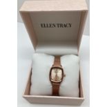 A ladies brand new boxed wristwatch by Ellen Tracy. Rose gold tone square shaped case with rose gold