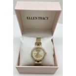 A brand new boxed ladies wristwatch by Ellen Tracy. Gold tone mesh strap with crystal set gold