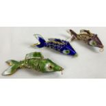 3 enamelled metal articulated fish pendants. In navy blue, pale green and mauve, with fully