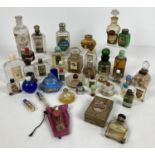 A collection of vintage perfume and smelling salt bottles, some still with contents. To include