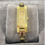 A boxed Ladies 3900L wristwatch by Gucci. Gold tone rectangular open links and watch case. Gold face