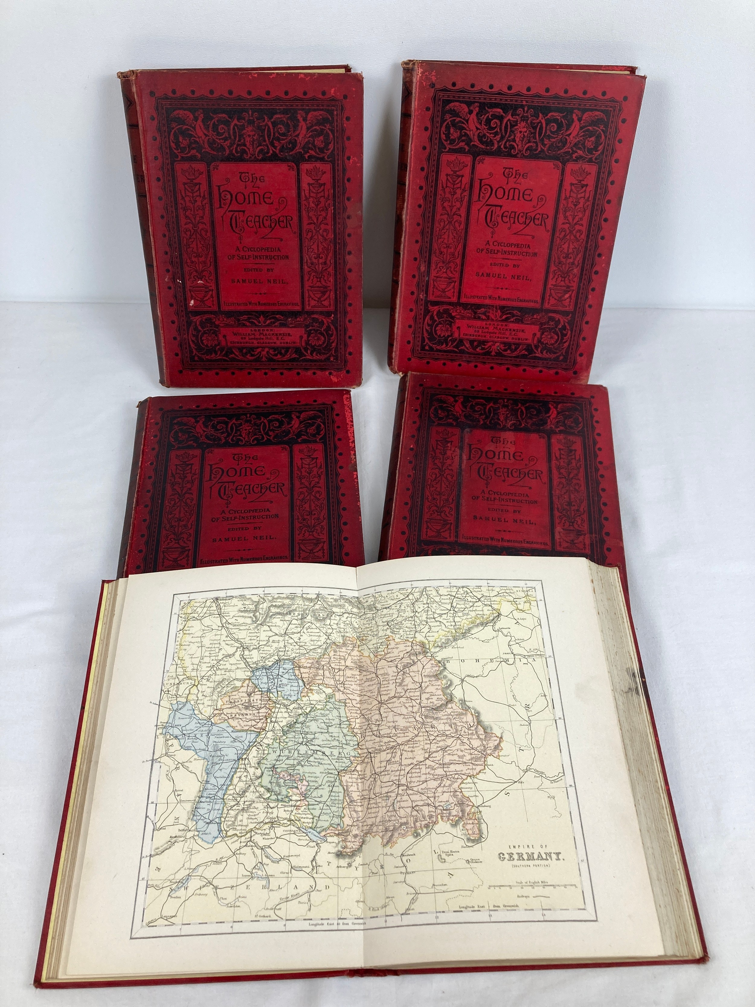 A set of 5 red cloth bound volumes of "The Home Teacher" edited by Samuel Neil. All books contain