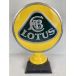 A large painted aluminium Lotus cars sign mounted on a black wooden base. Approx. 50cm tall x 38cm