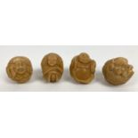 4 small carved spherical shaped figures, possibly from nuts. Each modelled as a different figure,