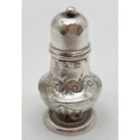 A decorative Victorian silver miniature pepperette with integral spoon. Hallmarked for Birmingham