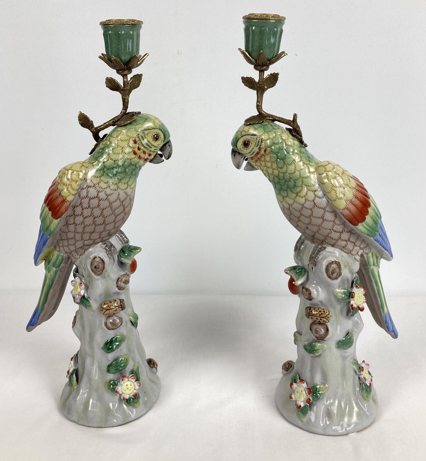 A pair of ceramic candlesticks modelled as parrots sitting atop a stump. With flower and insect - Image 3 of 4