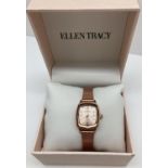A ladies brand new boxed wristwatch by Ellen Tracy. Rose gold tone square shaped case with rose gold