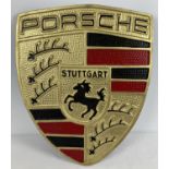 A large painted aluminium, Porsche shield shaped wall plaque, with fixing hooks to reverse. In