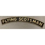 A large curve shaped cast metal Flying Scotsman wall hanging sign with fixing holes. In black and