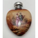 An early 20th century ceramic scent bottle with hallmarked silver screw top lid. Heart shaped bottle