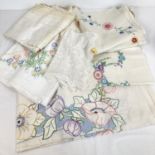 A small collection of vintage table linen in floral designs. To include 4 table cloths with