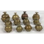A collection of 12 Indian elephant temple claw bells. All with engraved detail, in varying sizes.
