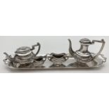 A hallmarked silver 5 piece miniature tea set of classical design. Comprising: water pot (with