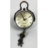 A brass bound ball watch pendant with tassel detail, roman numeral markers & hinged pendant bale.