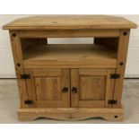 A modern Corona style pine media unit with black metal stud detail and round drop handles. Approx.