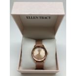 A brand new boxed ladies wristwatch by Ellen Tracy. Rose gold tone stainless steel case with bevel